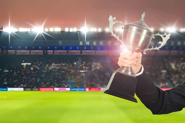 World Cup 2026 executive protection Mexico City concept with security professional holding trophy inside a packed stadium under bright lights